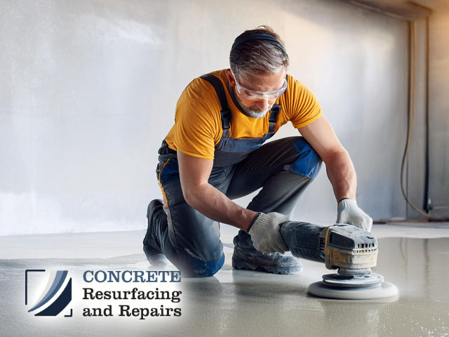 professional concrete resurfacing male technician professional working preparing concrete floor for polishing